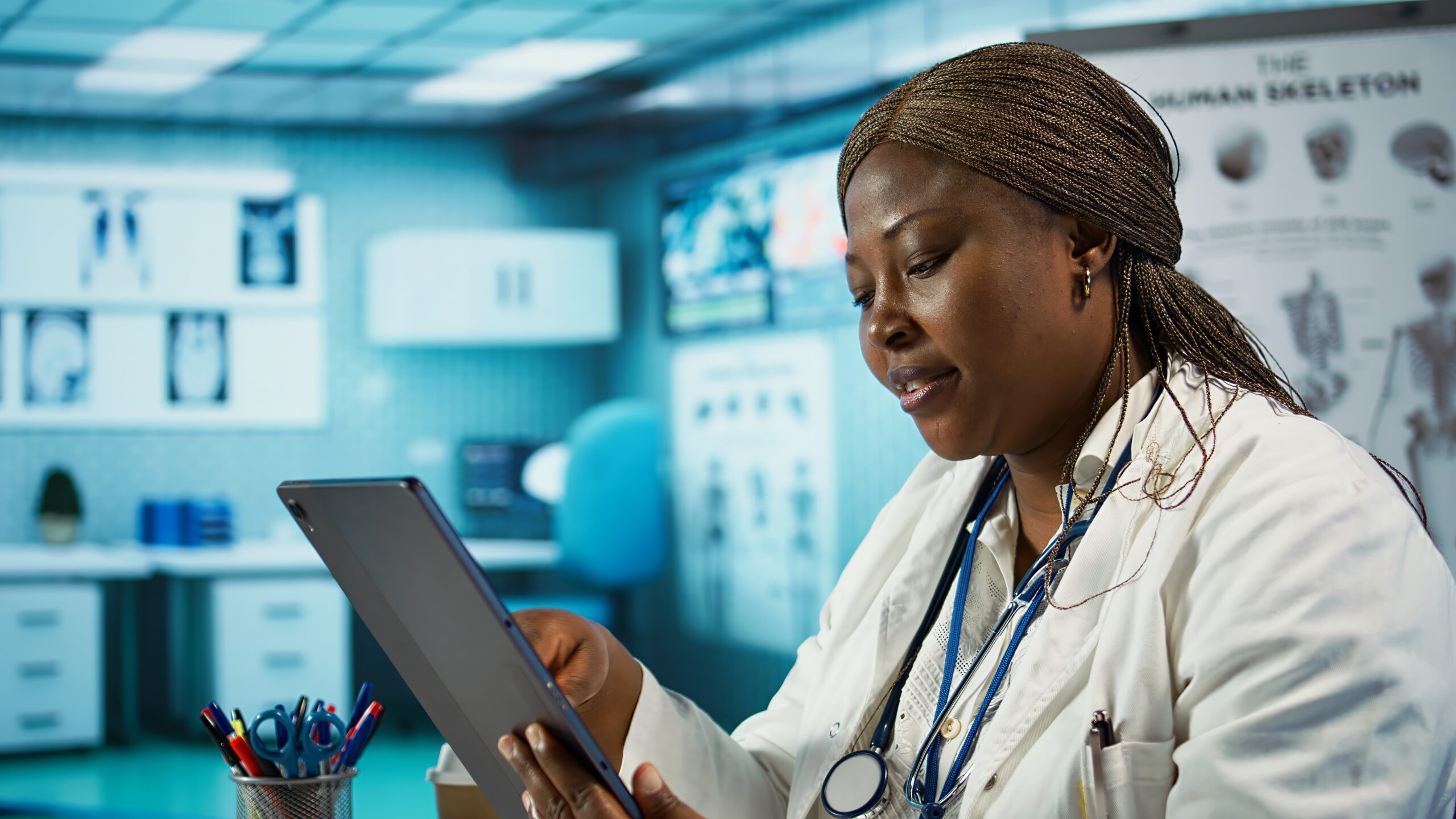 Black physician looking over clinical records to find treatment in her cabinet, working hard to help patients at the private clinic. Professional healthcare services within the industry. Camera B.